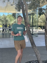 a man leaning against a tree