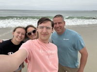 a group of people taking a selfie on the beach